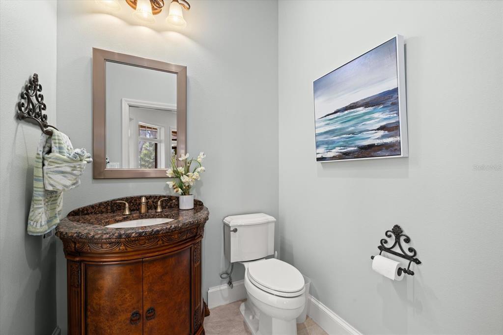 2115 Lychee Lane Nokomis, FL 34275 - Photo 51 of 85 a bathroom with a toilet a sink and mirror