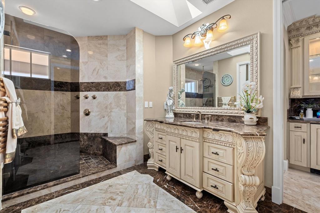 2115 Lychee Lane Nokomis, FL 34275 - Photo 56 of 85 a bathroom with a granite countertop sink a mirror and a shower