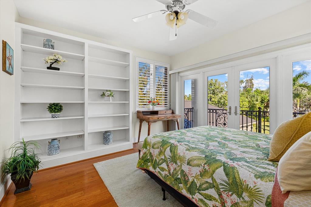 2115 Lychee Lane Nokomis, FL 34275 - Photo 63 of 85 a bedroom with a bed a table and a potted plant