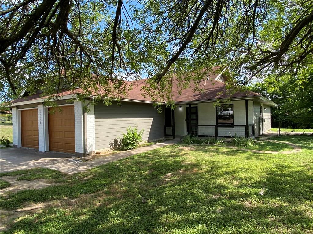 1715 Shadowview Drive, Unit B Austin, TX 78758 - Photo 2 of 28 A well-maintained facade with double garage doors and lush green landscaping creates an inviting exterior.