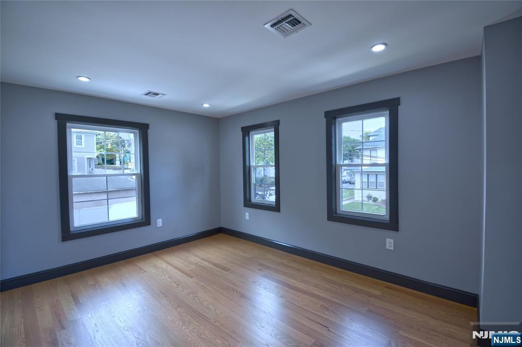 72 Hille Place Ridgefield Park, NJ 07660 - Photo 14 of 39 a view of an empty room with wooden floor and a window
