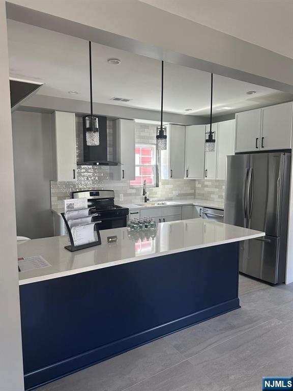 72 Hille Place Ridgefield Park, NJ 07660 - Photo 28 of 39 a kitchen with stainless steel appliances a sink a counter space and refrigerator