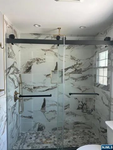 a bathroom with a shower toilet and sink