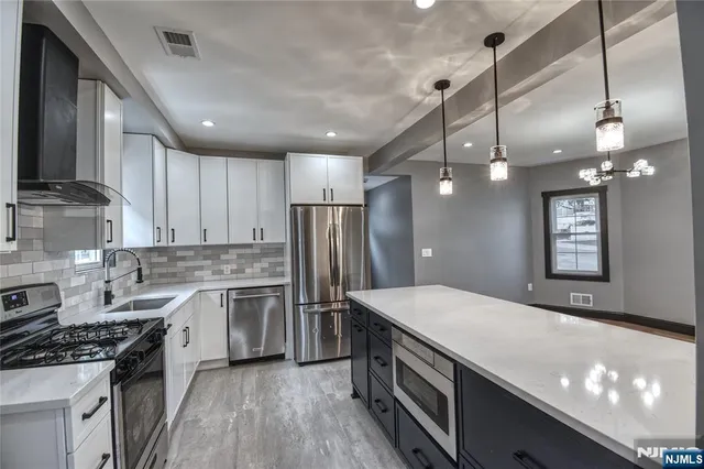 a kitchen with a stove a sink and a refrigerator