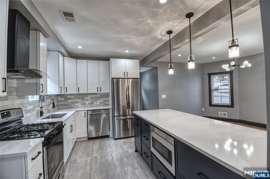 72 Hille Place Ridgefield Park, NJ 07660 - Photo 6 of 39 a kitchen with a stove a sink and a refrigerator