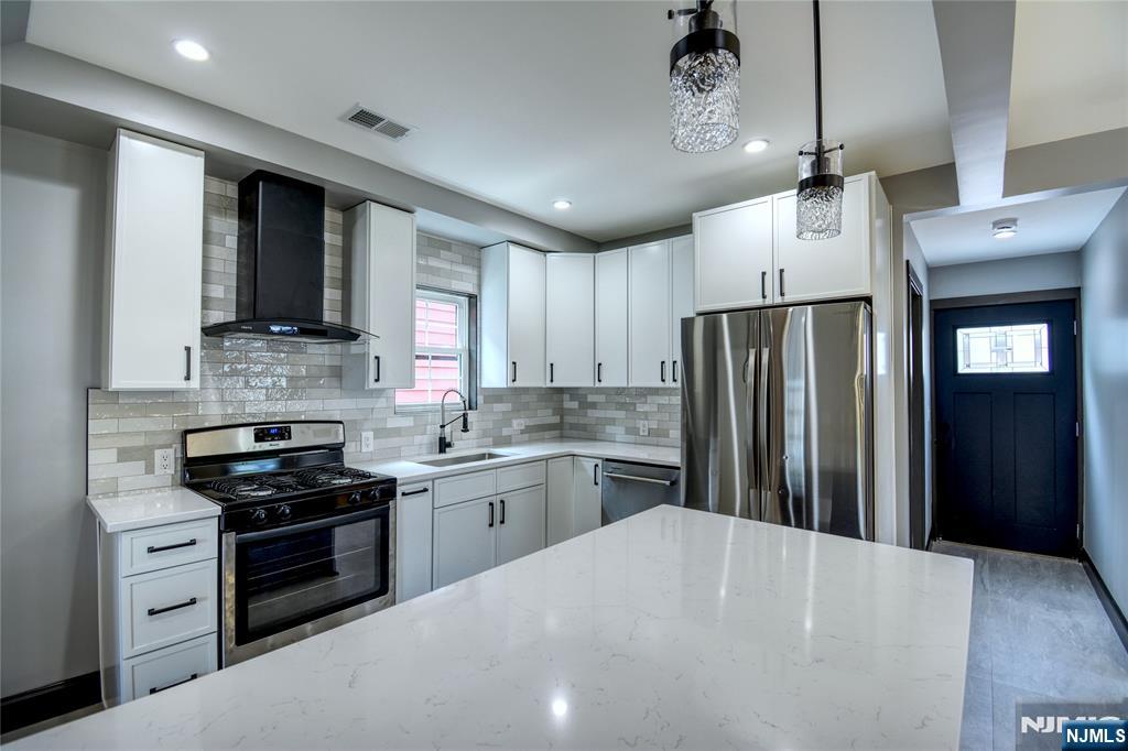 72 Hille Place Ridgefield Park, NJ 07660 - Photo 7 of 39 a kitchen with refrigerator a stove and a sink with cabinets