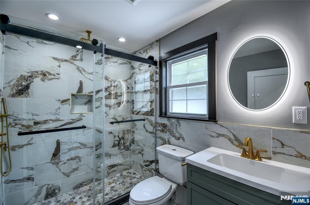 72 Hille Place Ridgefield Park, NJ 07660 - Photo 8 of 39 a bathroom with a toilet sink and mirror