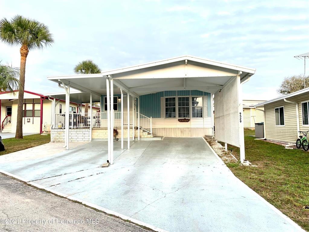 9529 Gray Fox Drive Weeki Wachee, FL 34613 - Photo 1 of 1 a swimming pool with outdoor seating and yard