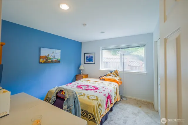 a bedroom with two beds and a window