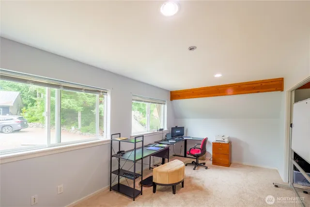 a living room with furniture a flat screen tv and a window