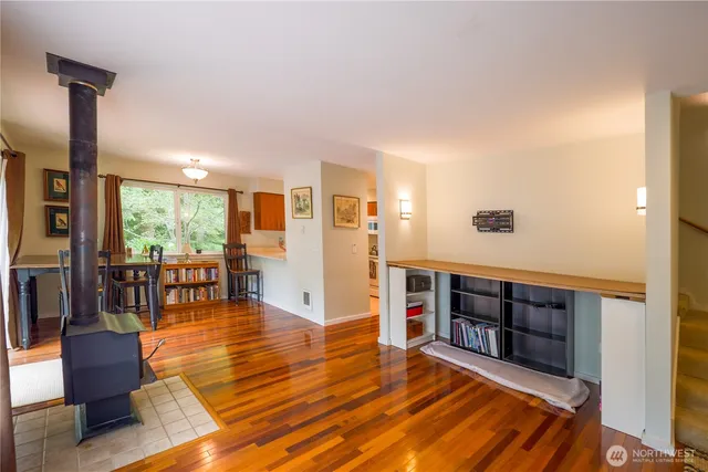 a living room with furniture and a table with wooden floor