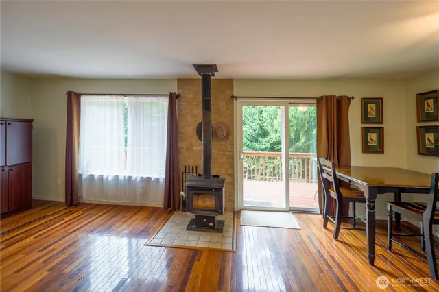 a furnished livingroom with windows and wooden floor