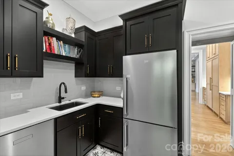 a kitchen with a refrigerator and a sink