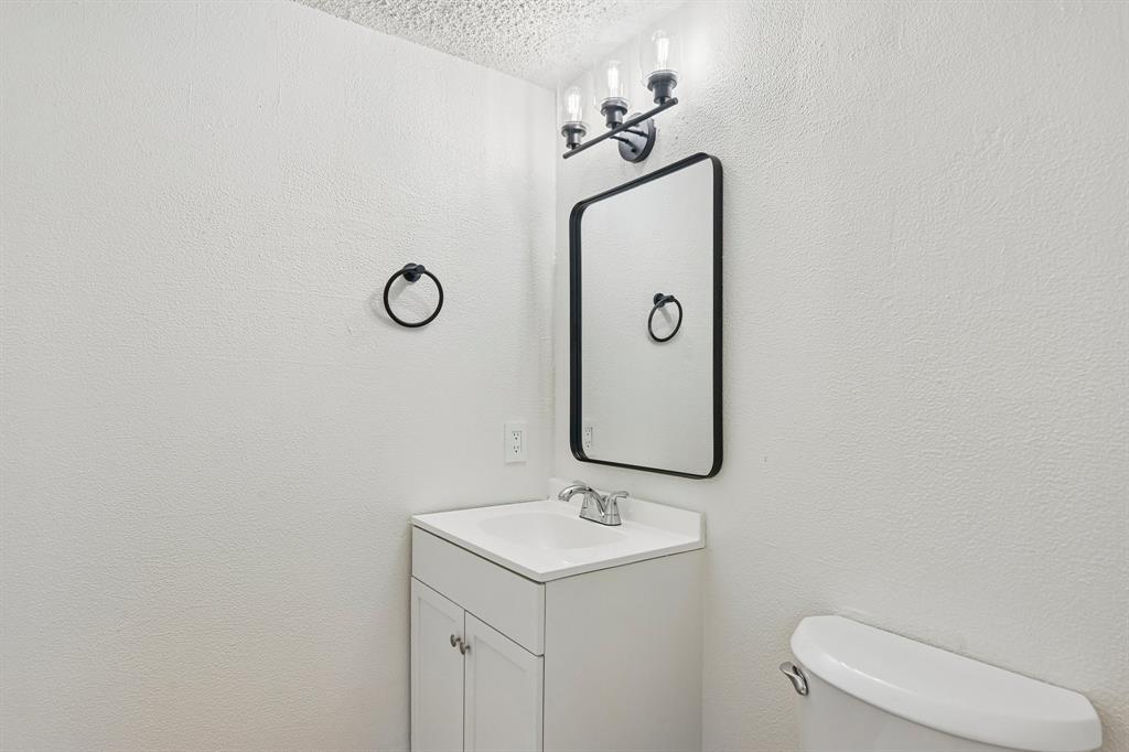 5300 Keller Springs Road, Unit 2055 Dallas, TX 75248 - Photo 15 of 24 Bathroom vanity with white cabinetry, integrated sink, and chrome faucet