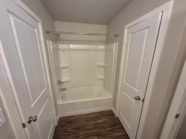 a bathroom with a tub and a shower