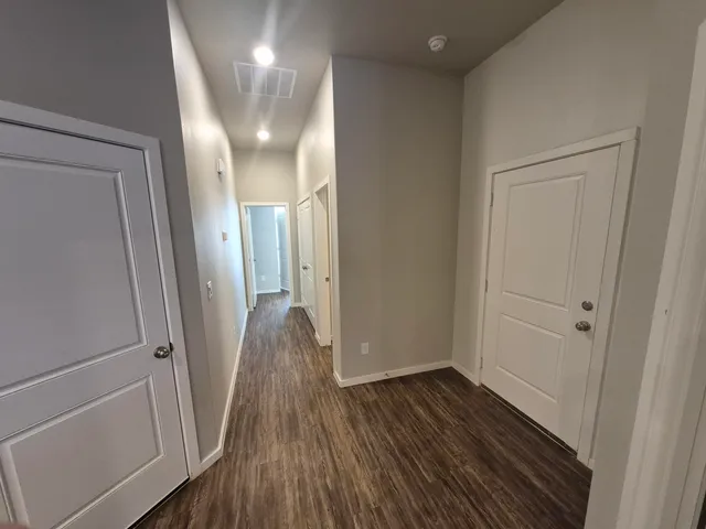 a view of hallway with wooden floor