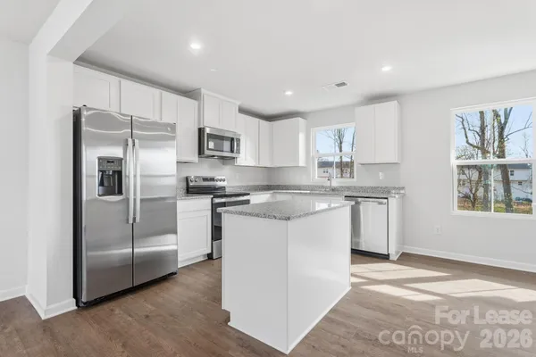 a kitchen with stainless steel appliances granite countertop a refrigerator sink and cabinets