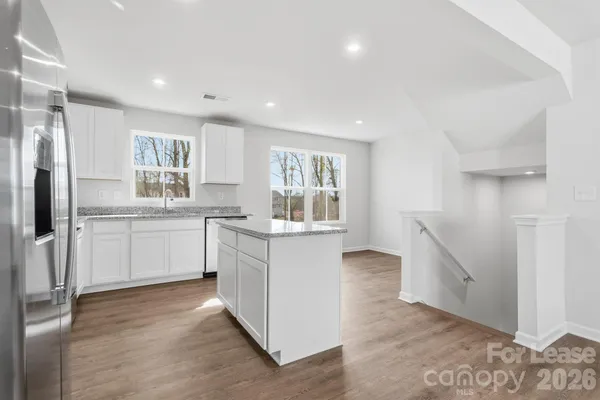 a kitchen with white cabinets and white appliances