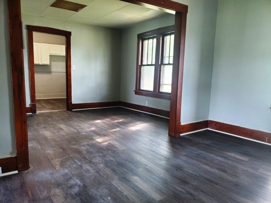 356 West Cypress Street Kankakee, IL 60901 - Photo 8 of 10 an empty room with wooden floor and windows