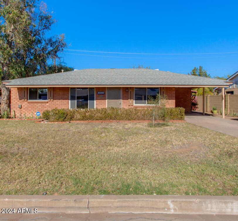 2752 West Lawrence Road Phoenix, AZ 85017 - Photo 1 of 23 a front view of house with yard and trees in the background