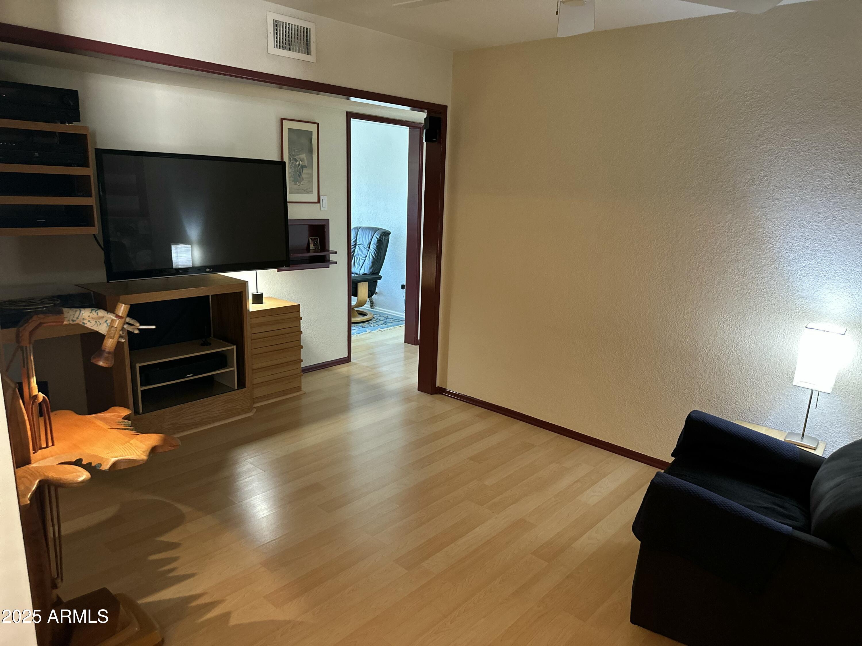 2752 West Lawrence Road Phoenix, AZ 85017 - Photo 12 of 23 a living room with furniture and a flat screen tv