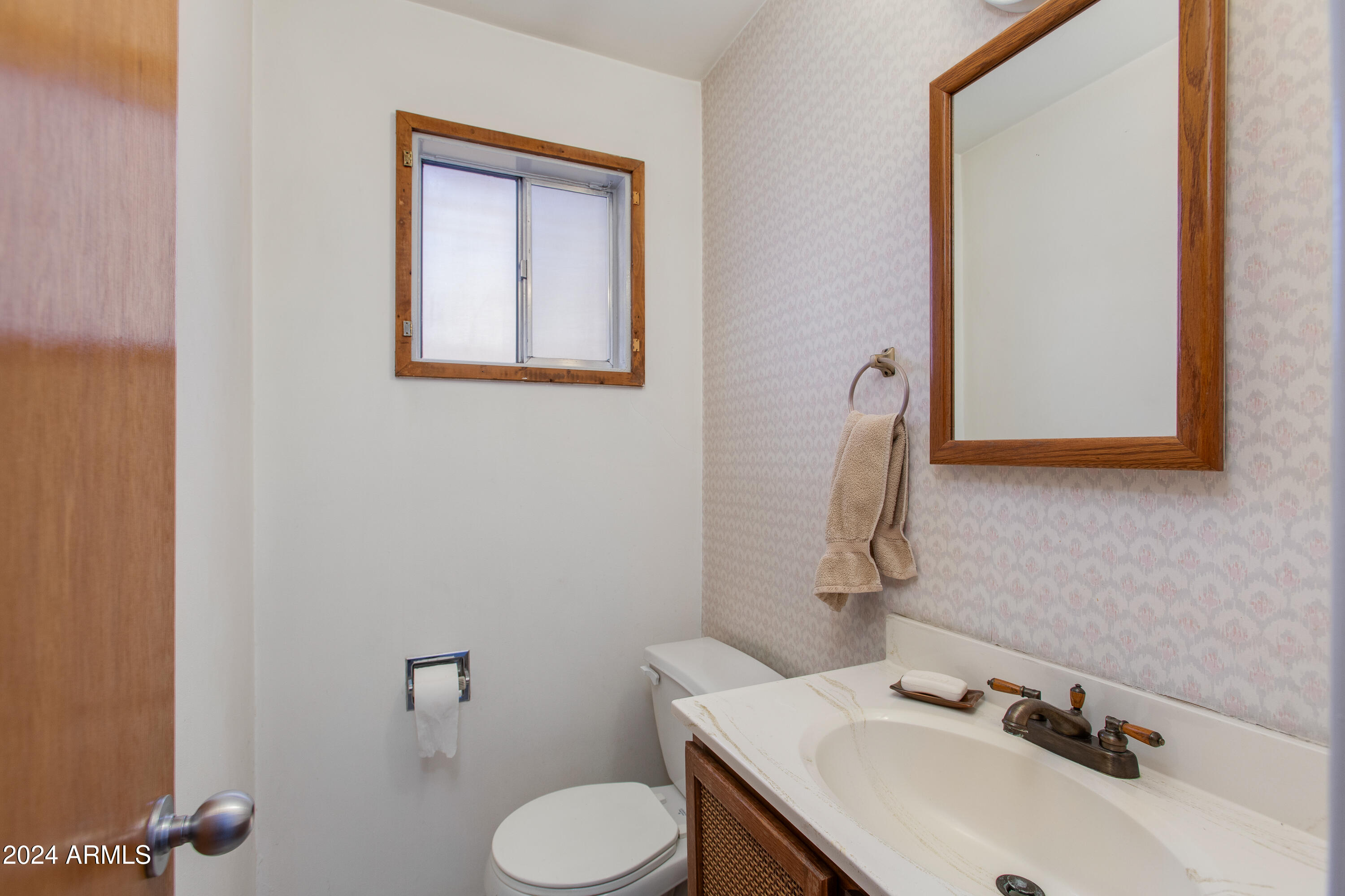 2752 West Lawrence Road Phoenix, AZ 85017 - Photo 13 of 23 a bathroom with a sink mirror and toilet