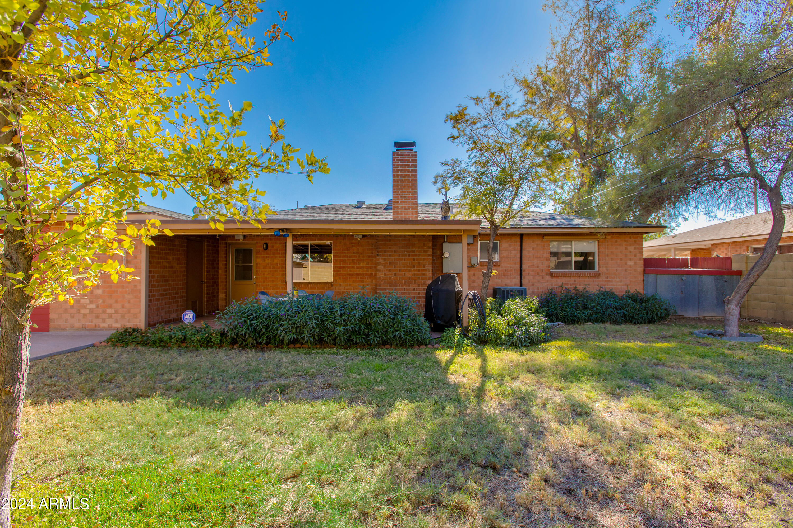 2752 West Lawrence Road Phoenix, AZ 85017 - Photo 21 of 23 a view of a house with a yard