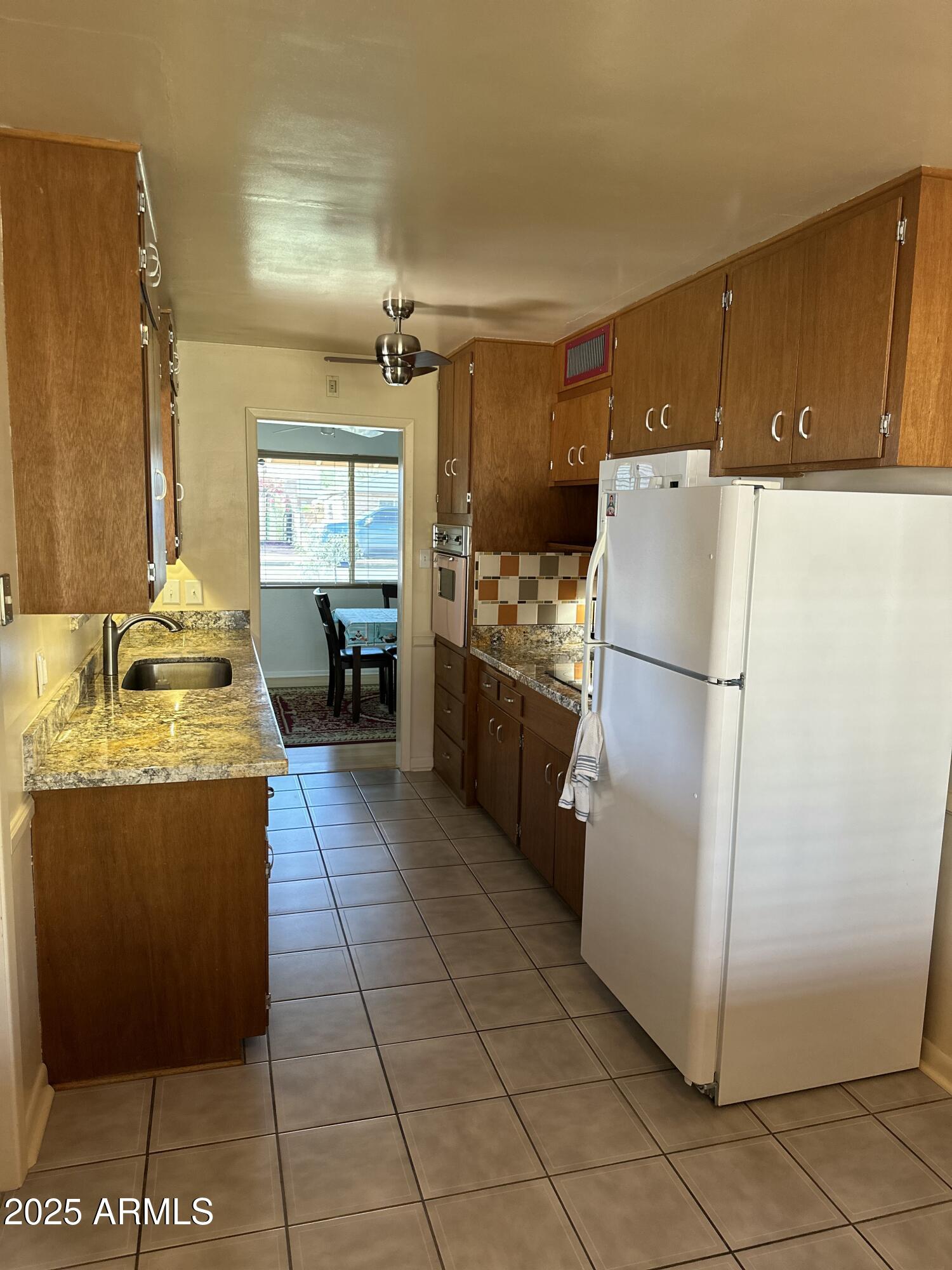 2752 West Lawrence Road Phoenix, AZ 85017 - Photo 4 of 23 a kitchen with granite countertop a refrigerator a stove and a refrigerator