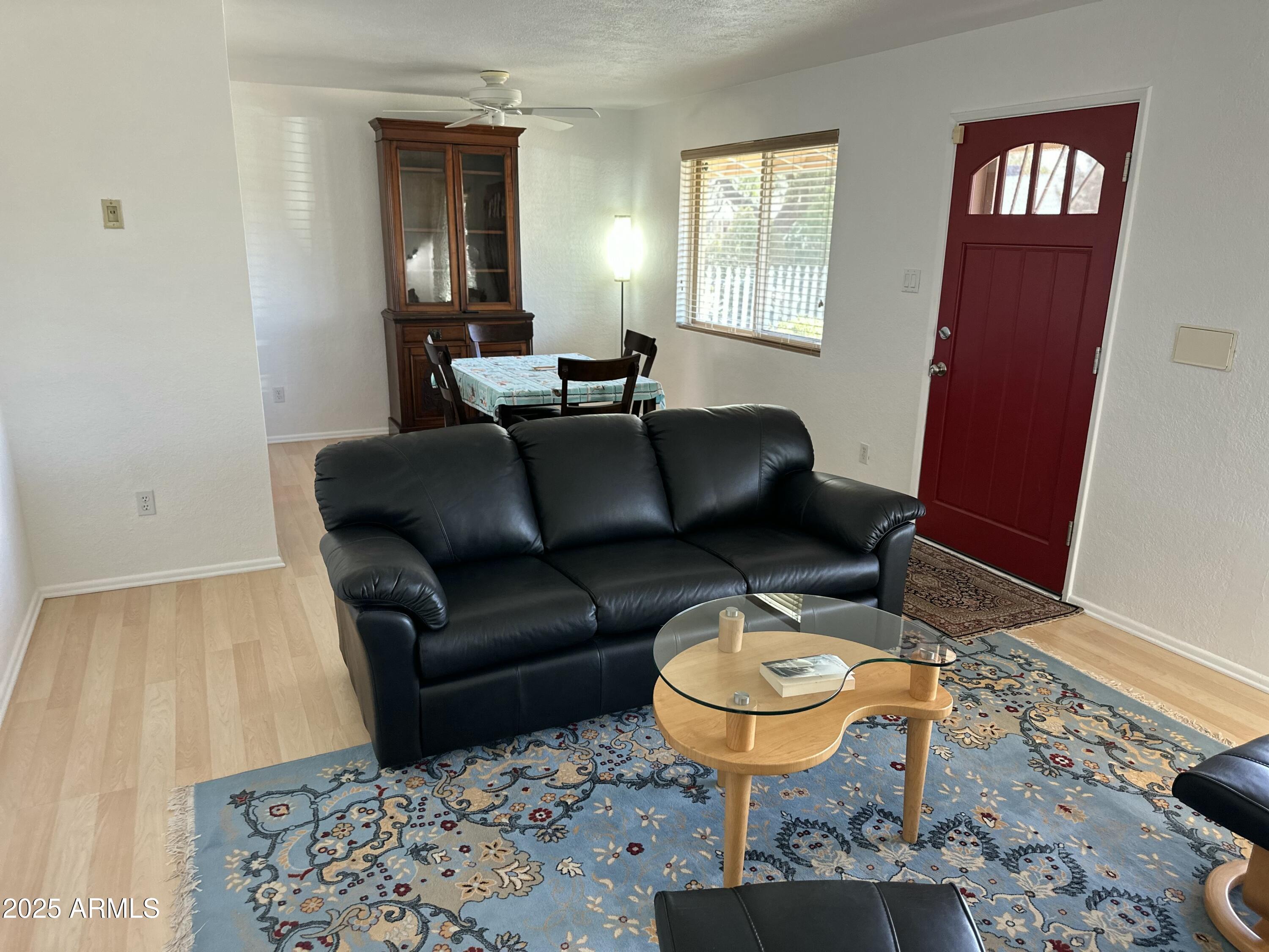 2752 West Lawrence Road Phoenix, AZ 85017 - Photo 6 of 23 a living room with furniture a rug and a window