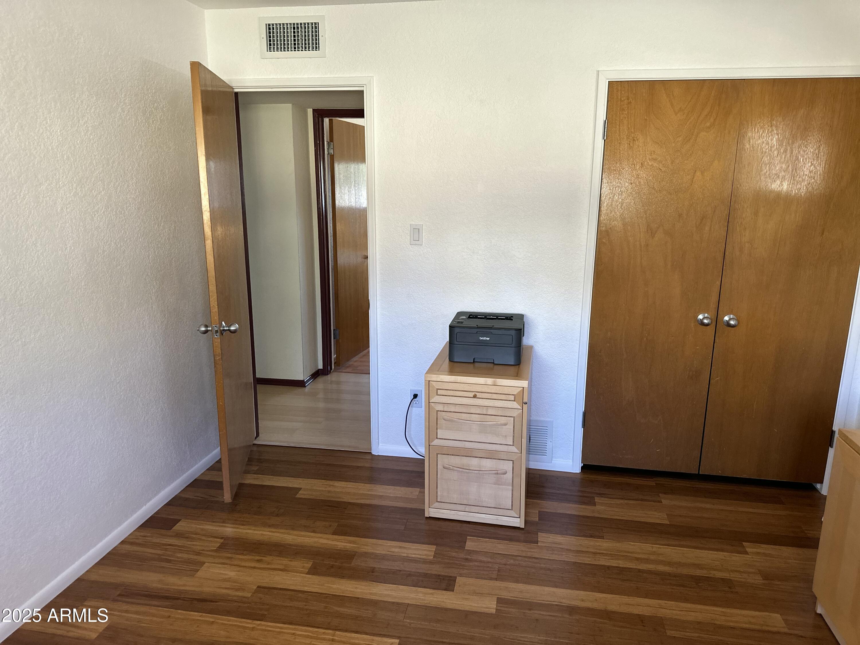 2752 West Lawrence Road Phoenix, AZ 85017 - Photo 9 of 23 a view of walk in closet with wooden floor