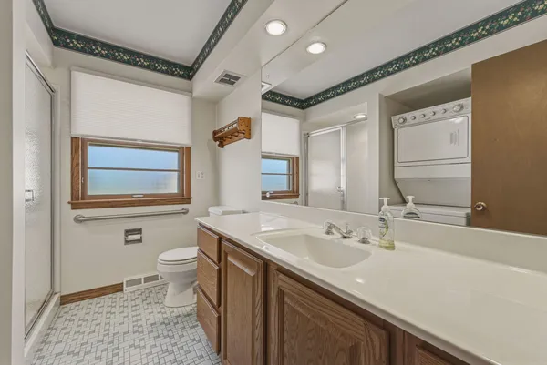 a bathroom with a sink a toilet and a mirror
