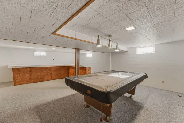 a room with pool table and a chandelier