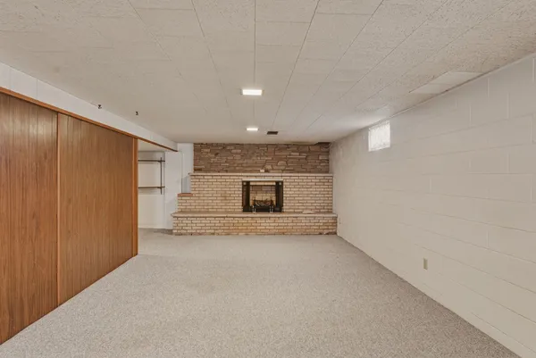 a view of empty room with a fireplace and cabinet
