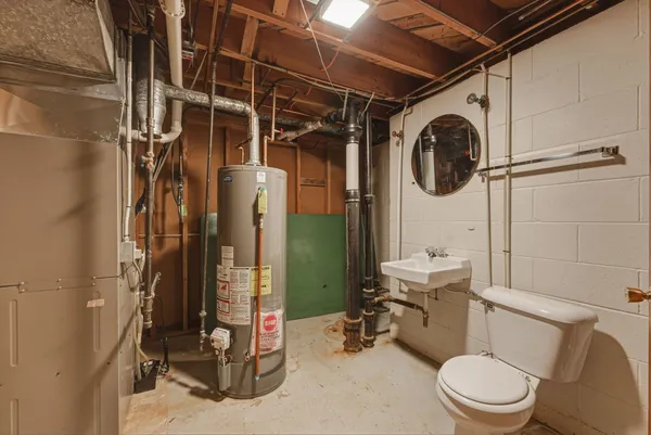 a bathroom with a toilet a sink and a shower