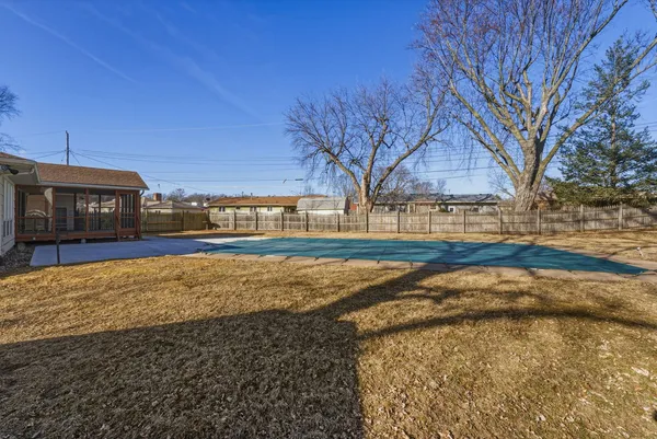 a view of an house with backyard and trees