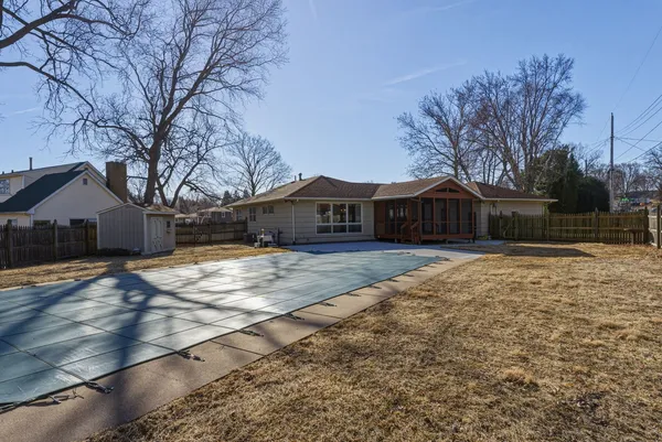 a front view of house with yard and trees in the background