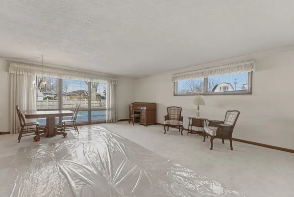 a bedroom with furniture and a large window