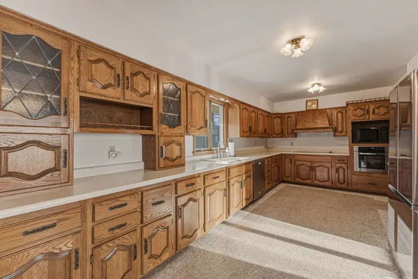 a kitchen with stainless steel appliances granite countertop a sink and cabinets