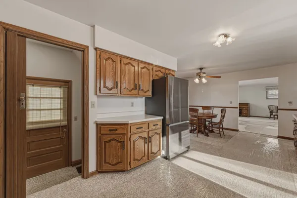 a view of kitchen with furniture and refrigerator
