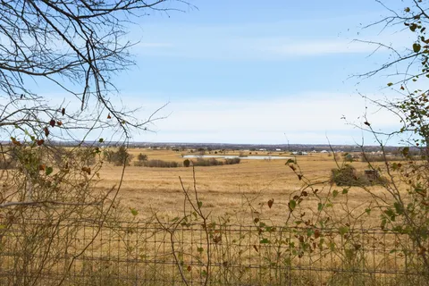 a front view of a house with a yard and lake view