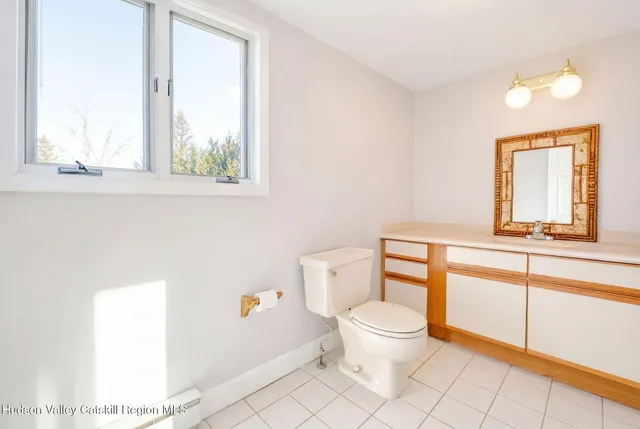 a bathroom with a toilet a sink and a window