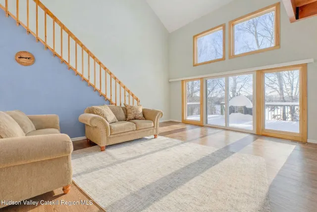 a living room with furniture and a large window with outer view