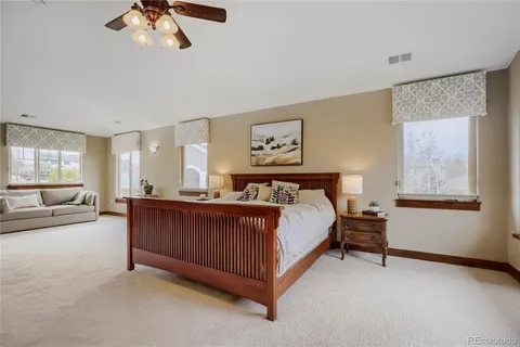 a bedroom with a bed next to a window