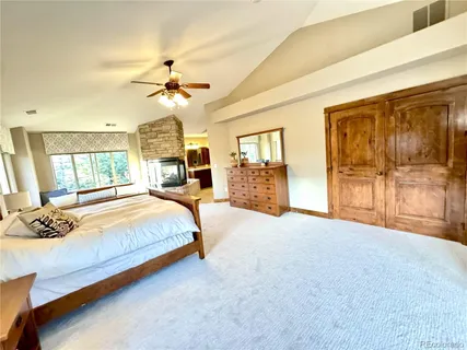 a kitchen with stainless steel appliances granite countertop a table chairs sink and cabinets