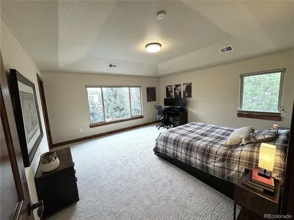 a view of a house with backyard porch and sitting area