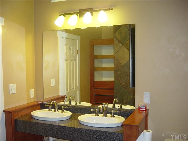 4808 Gun Powder Place Raleigh, NC 27616 - Photo 13 of 23 a bathroom with a sink and a mirror