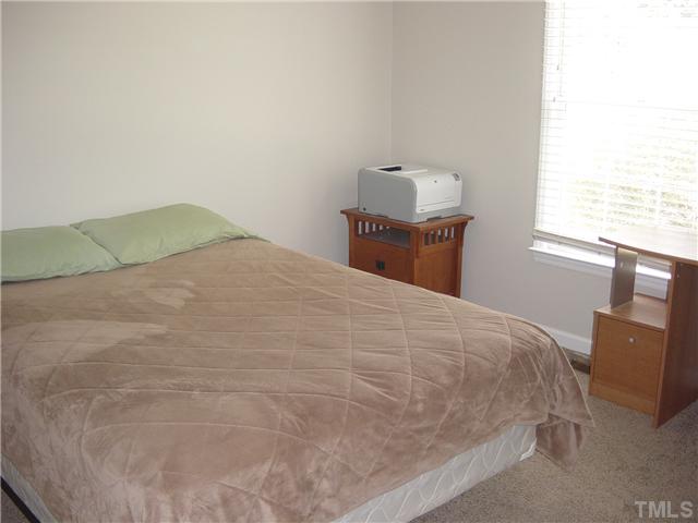 4808 Gun Powder Place Raleigh, NC 27616 - Photo 17 of 23 a bed sitting in a bedroom next to a window