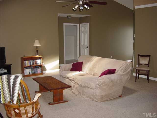 4808 Gun Powder Place Raleigh, NC 27616 - Photo 3 of 23 a living room with furniture a dining table and a bookshelf