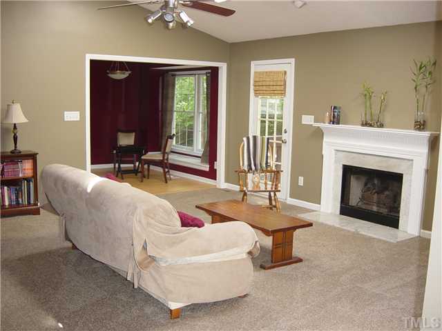 4808 Gun Powder Place Raleigh, NC 27616 - Photo 5 of 23 a living room with furniture a fireplace and a table