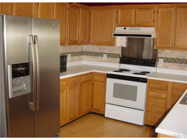 4808 Gun Powder Place Raleigh, NC 27616 - Photo 7 of 23 a kitchen with stainless steel appliances a stove and a refrigerator